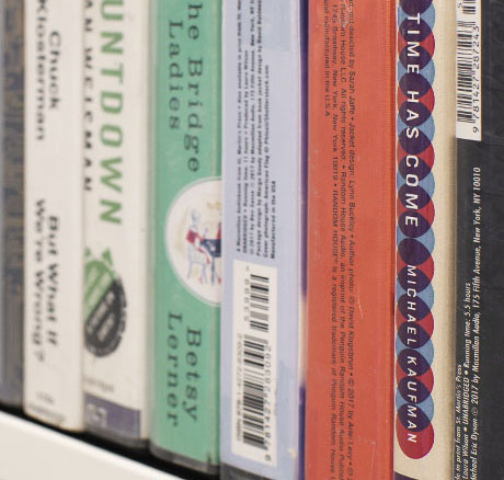 Audiobooks on a bookshelf.