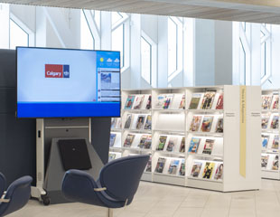 A flatscreen TV with a special speaker for accessibility in a library.
