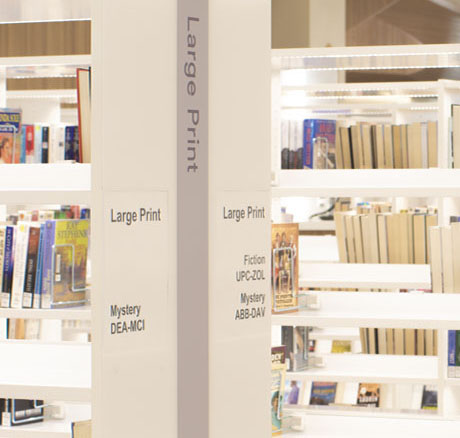 Library bookshelves with text that reads Large Print.