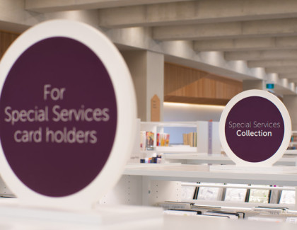 A photo of a sign on top of a bookshelf that says "For Special Services card holders" 