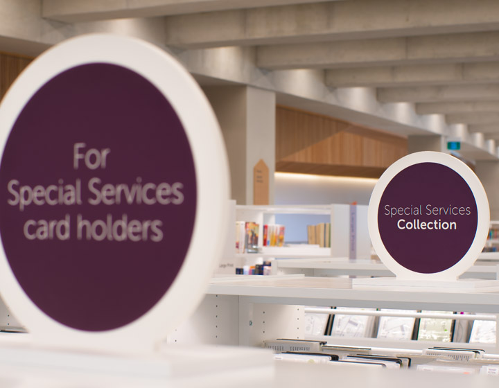background image: A photo of a sign on top of a bookshelf that says "For Special Services card holders" 