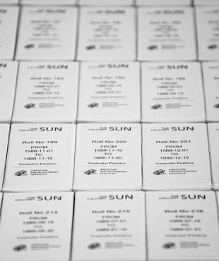 Rows of archival boxes labeled with the Calgary Sun newspaper logo.