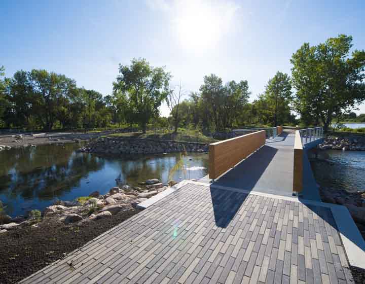 background image: A beautiful shot of the bridge over the Bow and Elbow river, which is known as Moh’kinsstis to the Blackfoot — a gathering place for Indigenous peoples for thousands of years.