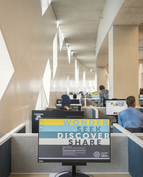 A visual of a desktop computer that has "Wonder, Seek, Discover and Share" written on it. 