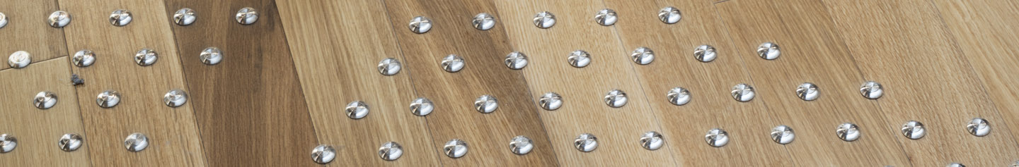 A visual of tactile features, silver circles on a wall at Central Library. 