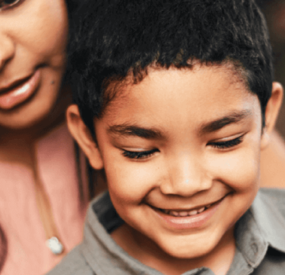 Photograph of a woman and a child reading together. 