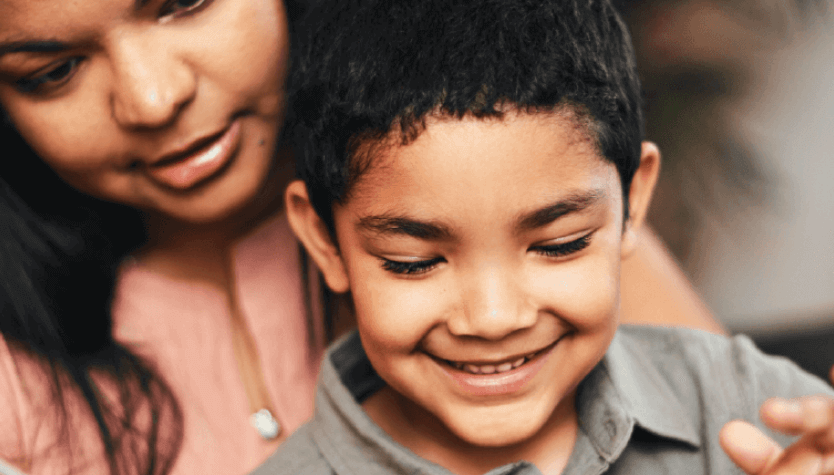 Photograph of a woman and a child reading together. 