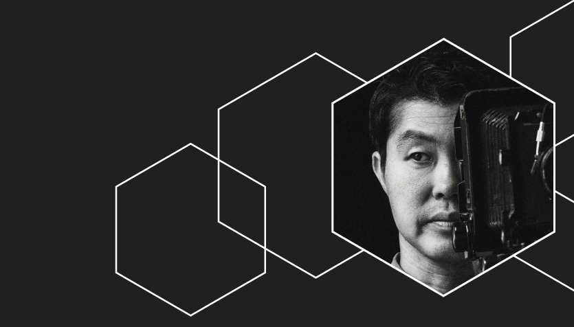 Graphic with a black background and hexagonal shapes outlined in white. In the centre hexagon is a photo of Han Sungpil