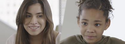 A photo of a woman and little girl looking at the camera