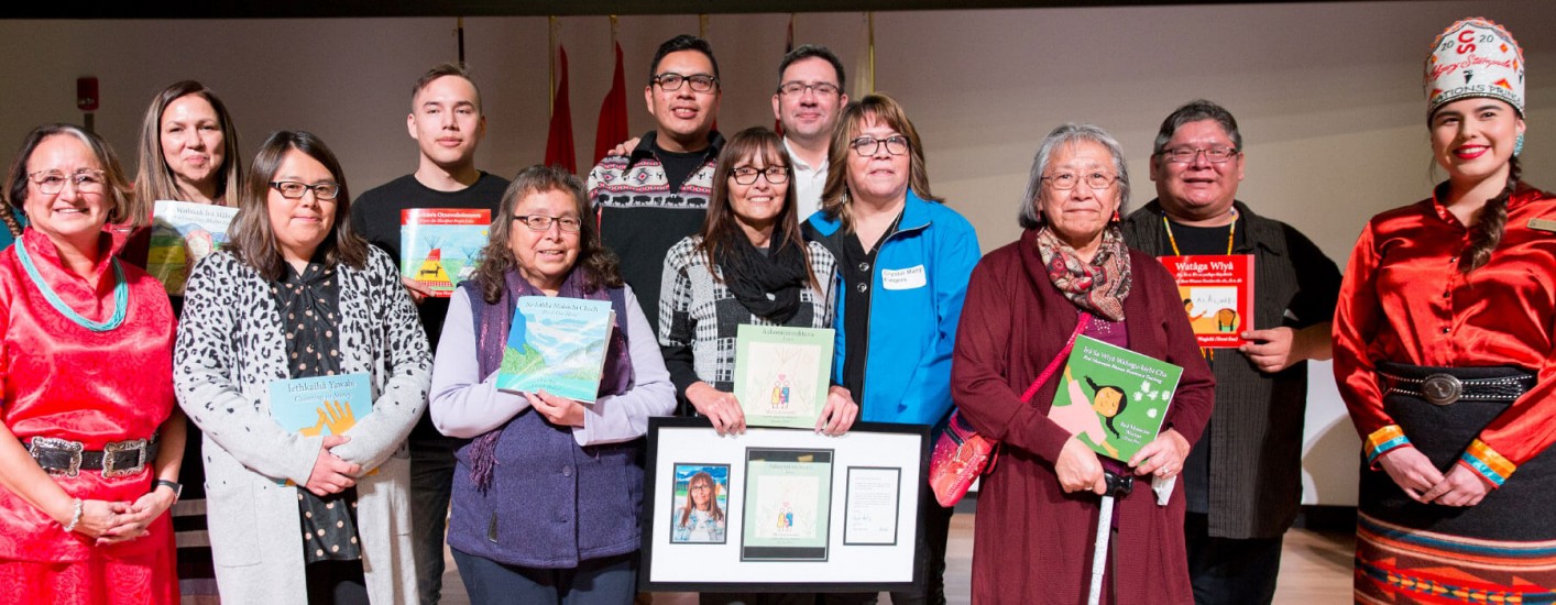 A group photo of the authors holding their books.