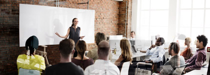 A classroom with a professor teaching in front.