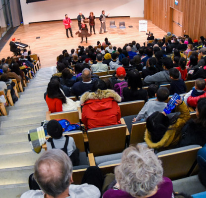 Photograph of a group of people in a performance hall. 