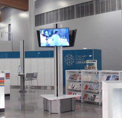 A photograph of a large space with bookshelves and tables.