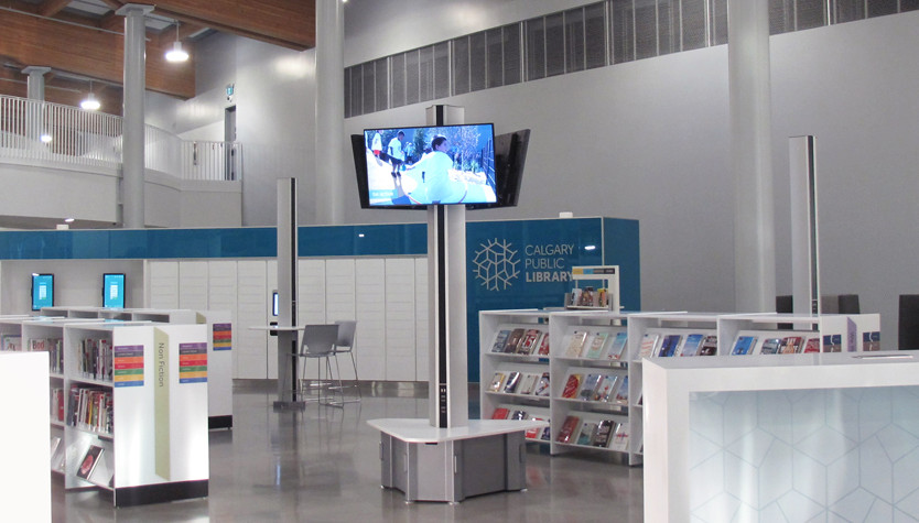 A photograph of a large space with bookshelves and tables.
