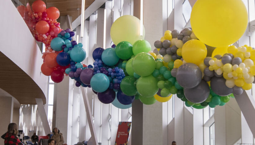 Photograph of the interior of Central Library. There is a large balloon installation suspended to the ceiling. 