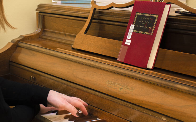 A photograph of a person playing a piano. 