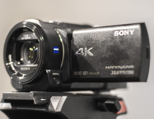 A photograph of a Sony 4k video camera mounted on a tripod.