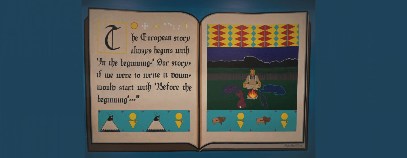 A painting of an open book. The left page has text stating, The European story always begins with 'in the beginning.' Our story...would start with 'Before the Beginning'" The right page shows a stylized scene with a teepee and campfire. 