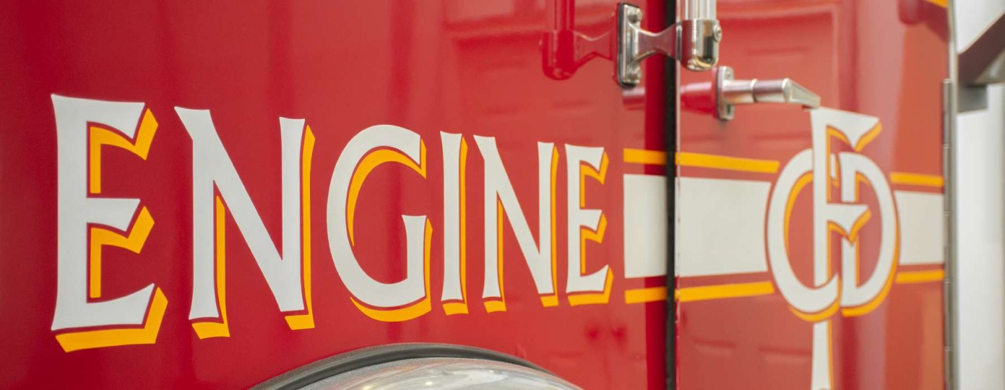 The side of a firetruck with the word Engine written on it.