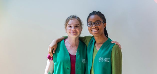 Two Calgary Public Library volunteers standing together.