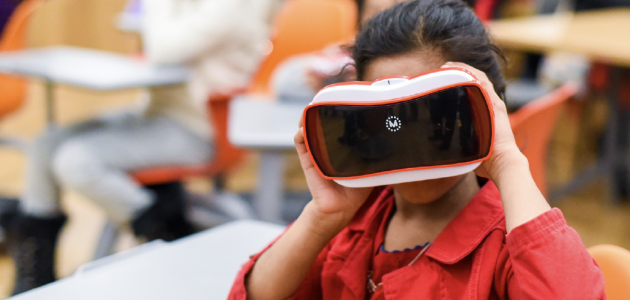 An image of a little girl holding a view master.