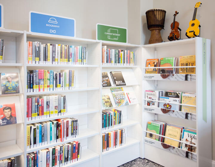 background image: A photograph of the Musical Instrument Lending Library at Memorial Park Library. On top of the shelves are a drum, violin and ukelele. 