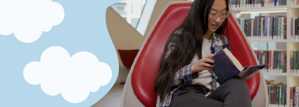 A teen sitting in an egg chair at Central Library reading a book.