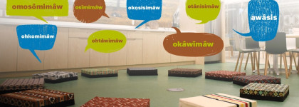 Children's Lodge with cushions on the ground and speech bubbles with words in Nehiyawewin Cree for the Introductory Language Program