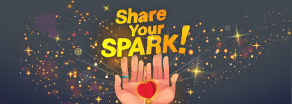 Two hands hold a red heart under the words Share Your Spark! with a black background and yellow stars.
