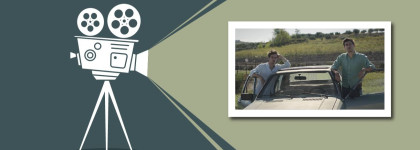 Illustration of a film projector displaying an image of two people standing beside a car outdoors.