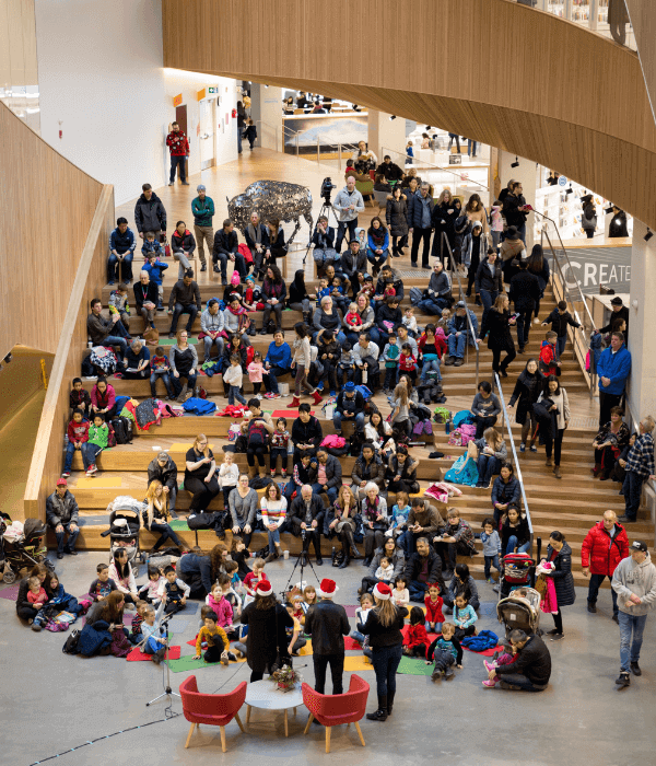 Central Library welcome gallery full of people watching a performance.