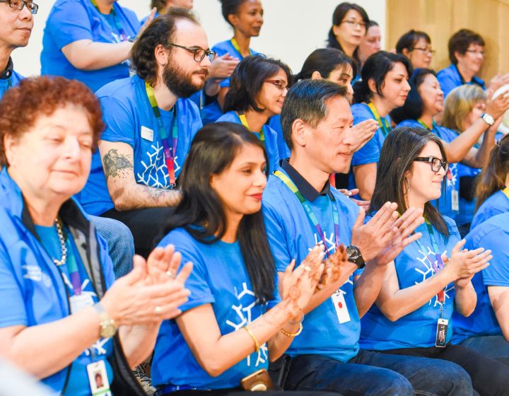 An audience of Calgary Public Library staff clapping. 